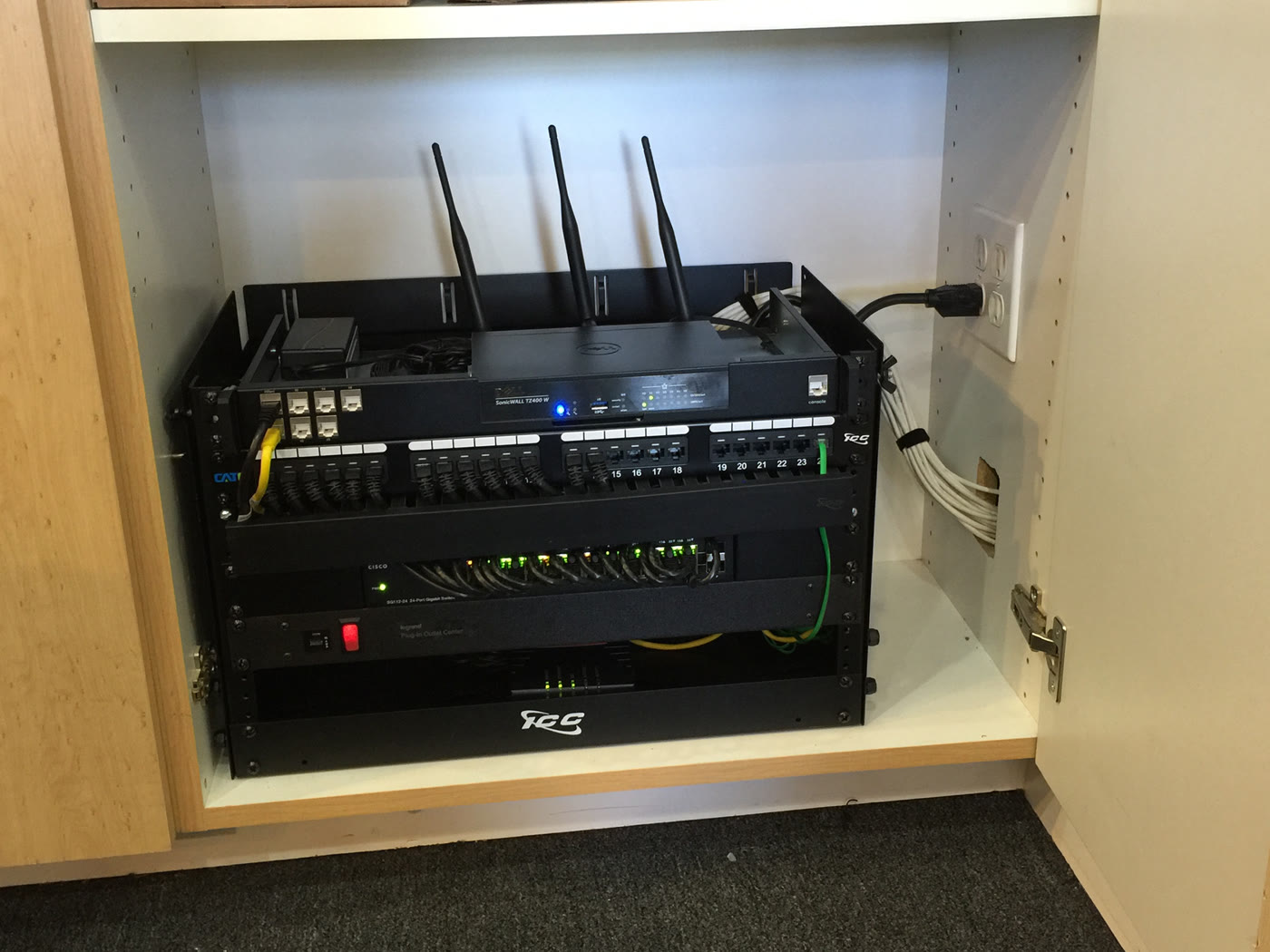 Real dental-office network cabinet with switching, patching, power, and organized cabling