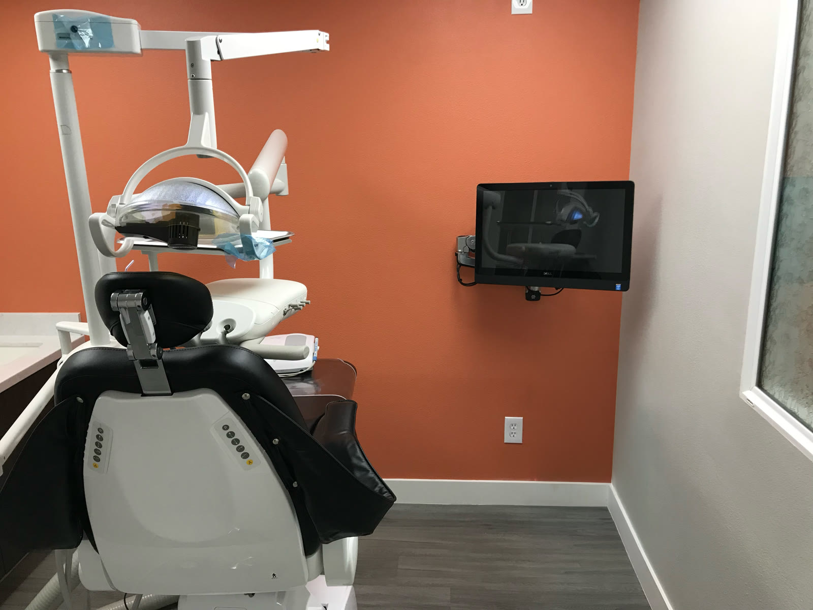 Wall-mounted clinical workstation installed beside a dental operatory